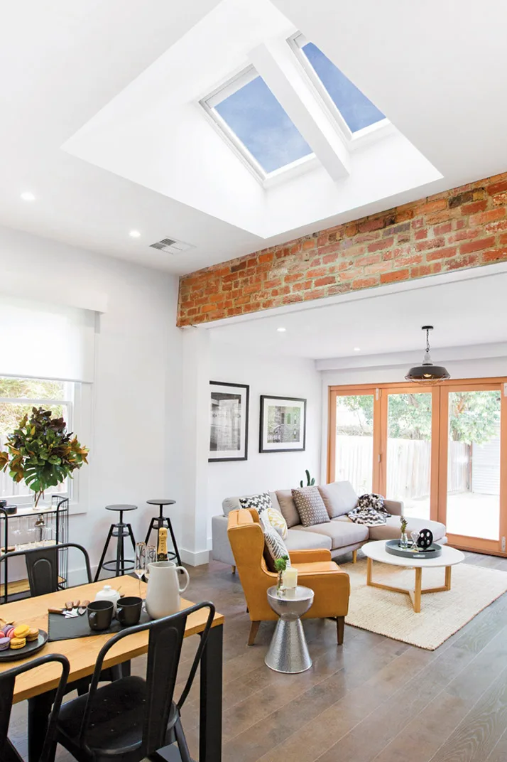 Daylight entering a living room through roof skylights